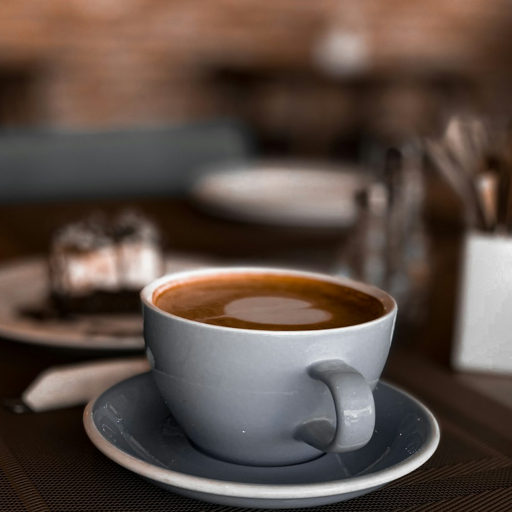 white ceramic cup on white ceramic saucer