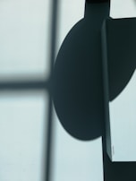 An abstract play of shadows and light on textured urban walls.