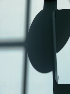 Abstract composition of light and shadow creating geometric shapes on a smooth surface