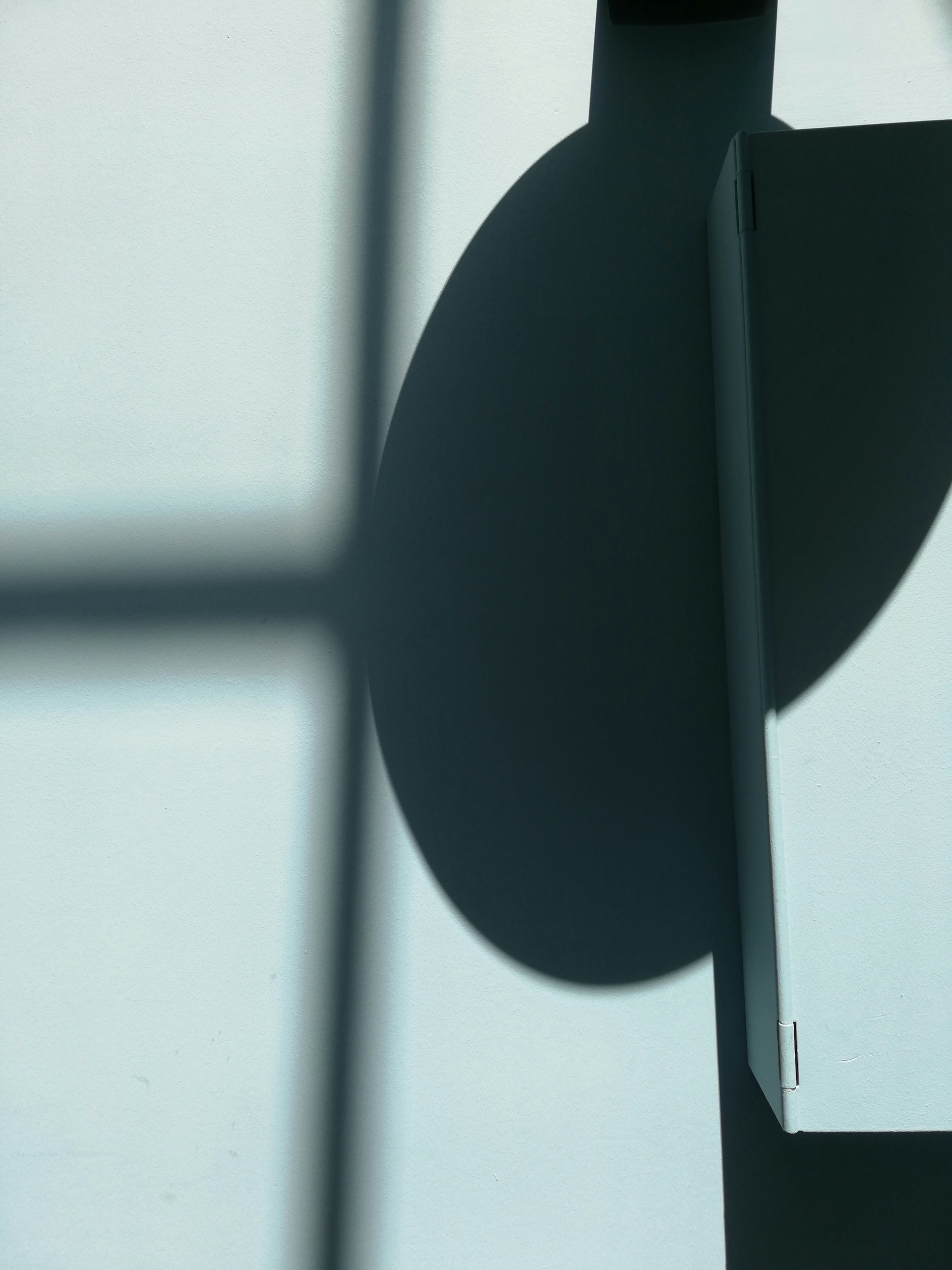 An abstract play of light and shadow on architectural surfaces, suggesting layers of awareness and the unfolding of subtle human experience.