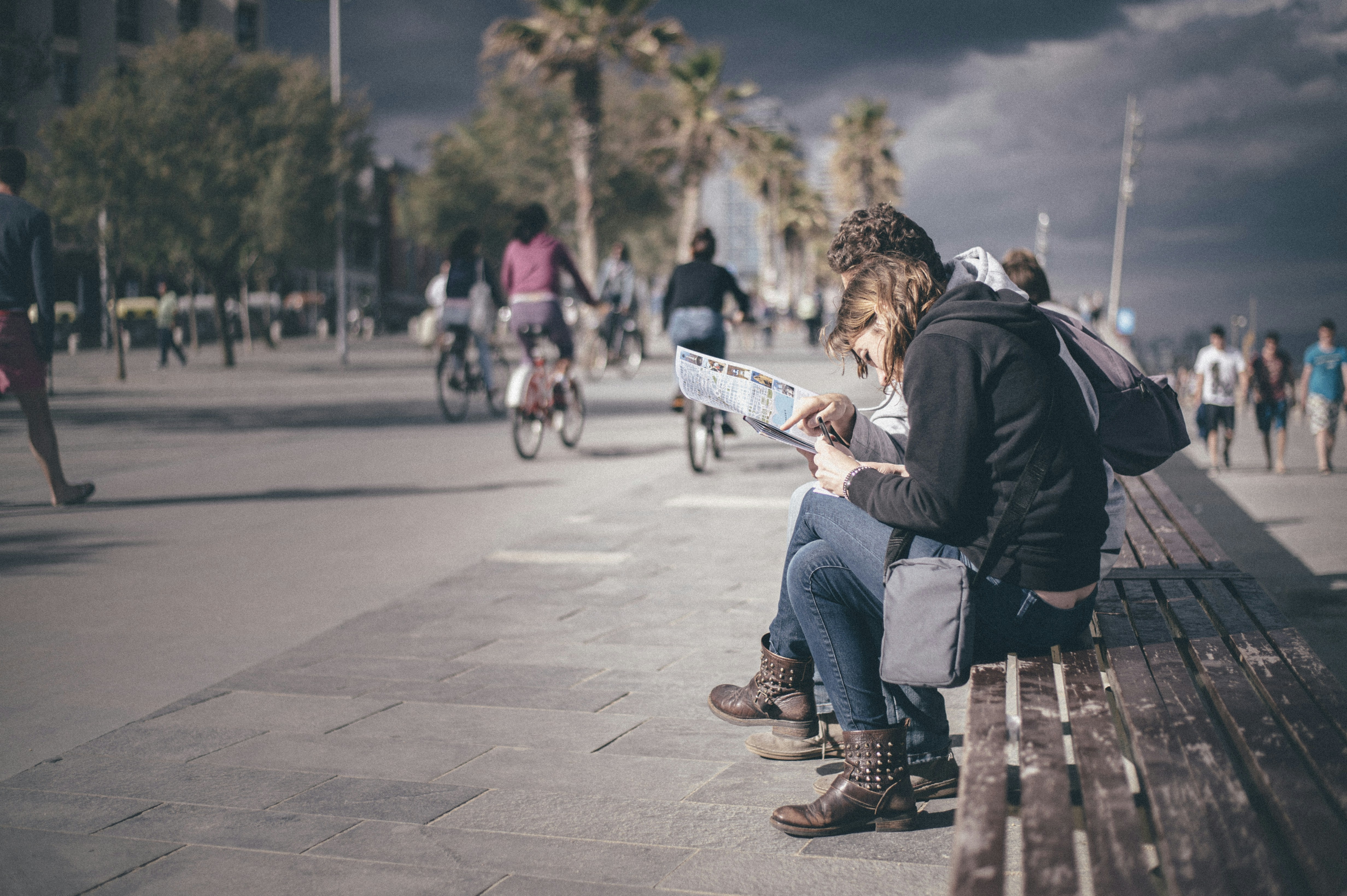 Tourists looking at the map on the Barcelona promenade.