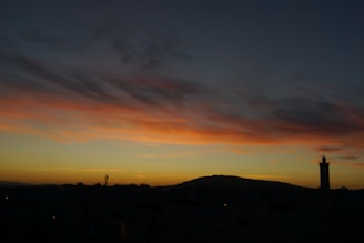 A serene Islamic landscape with a mosque at sunset.
