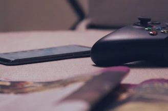 A developer testing an Android game on a smartphone in a cozy workspace.