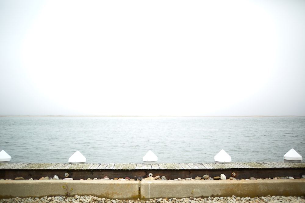 gray concrete wall near body of water during daytime