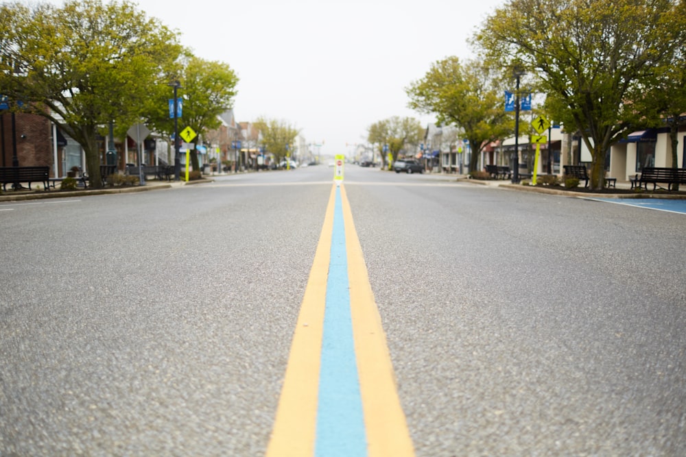 yellow line on gray asphalt road during daytime