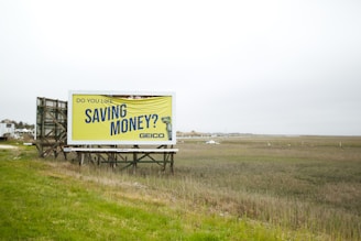 a billboard on the side of a road advertising saving money