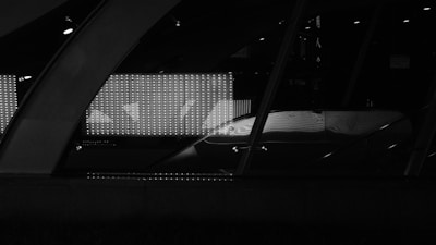 Top view photo of a modern V16 beacon placed on a smooth black surface with bright reflections.