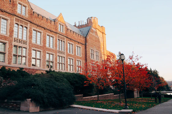 Historic brick building of George Washington Lodge #9 surrounded by mature trees on a sunny day.