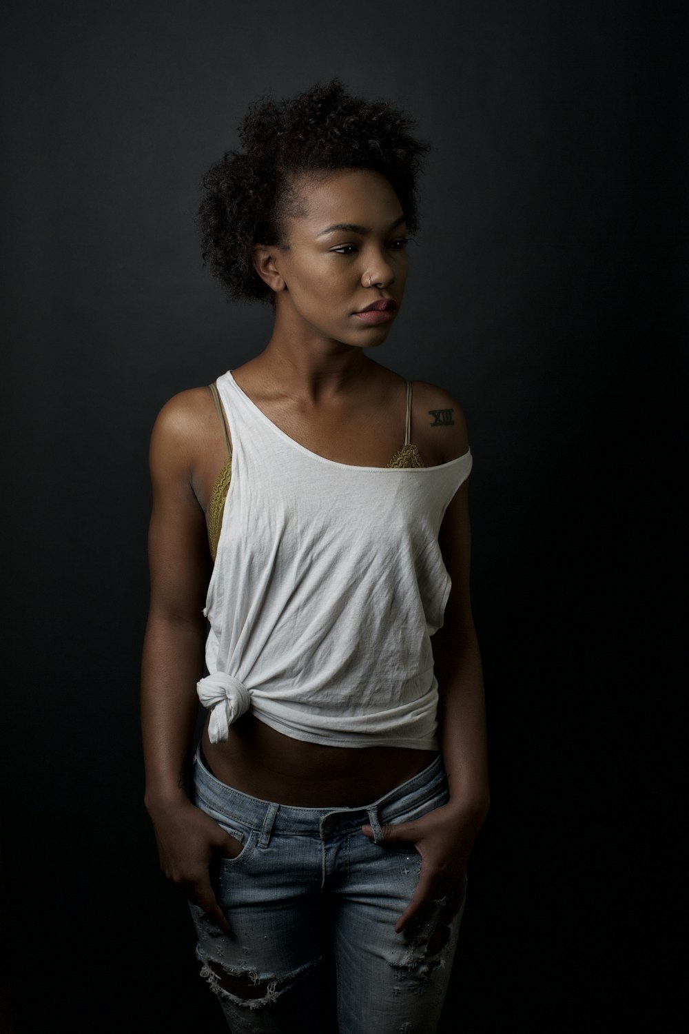 woman in white tank top and blue denim shorts