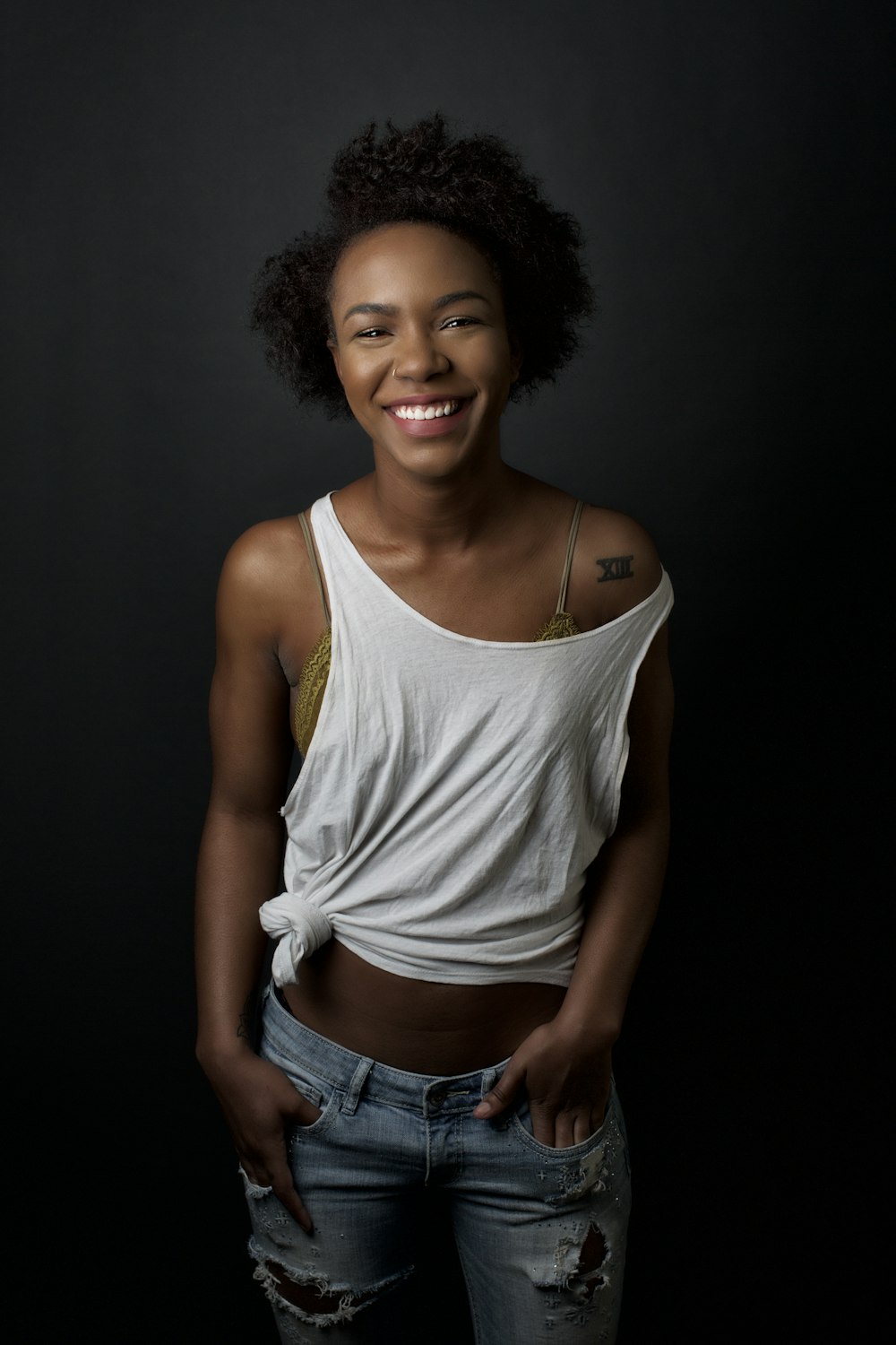 woman in white tank top and blue denim shorts