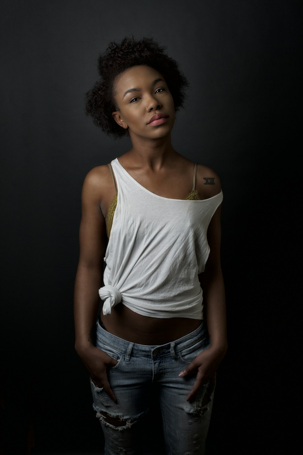 woman in white tank top and blue denim shorts