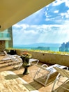 Rooftop terrace with panoramic views and lounge chairs.