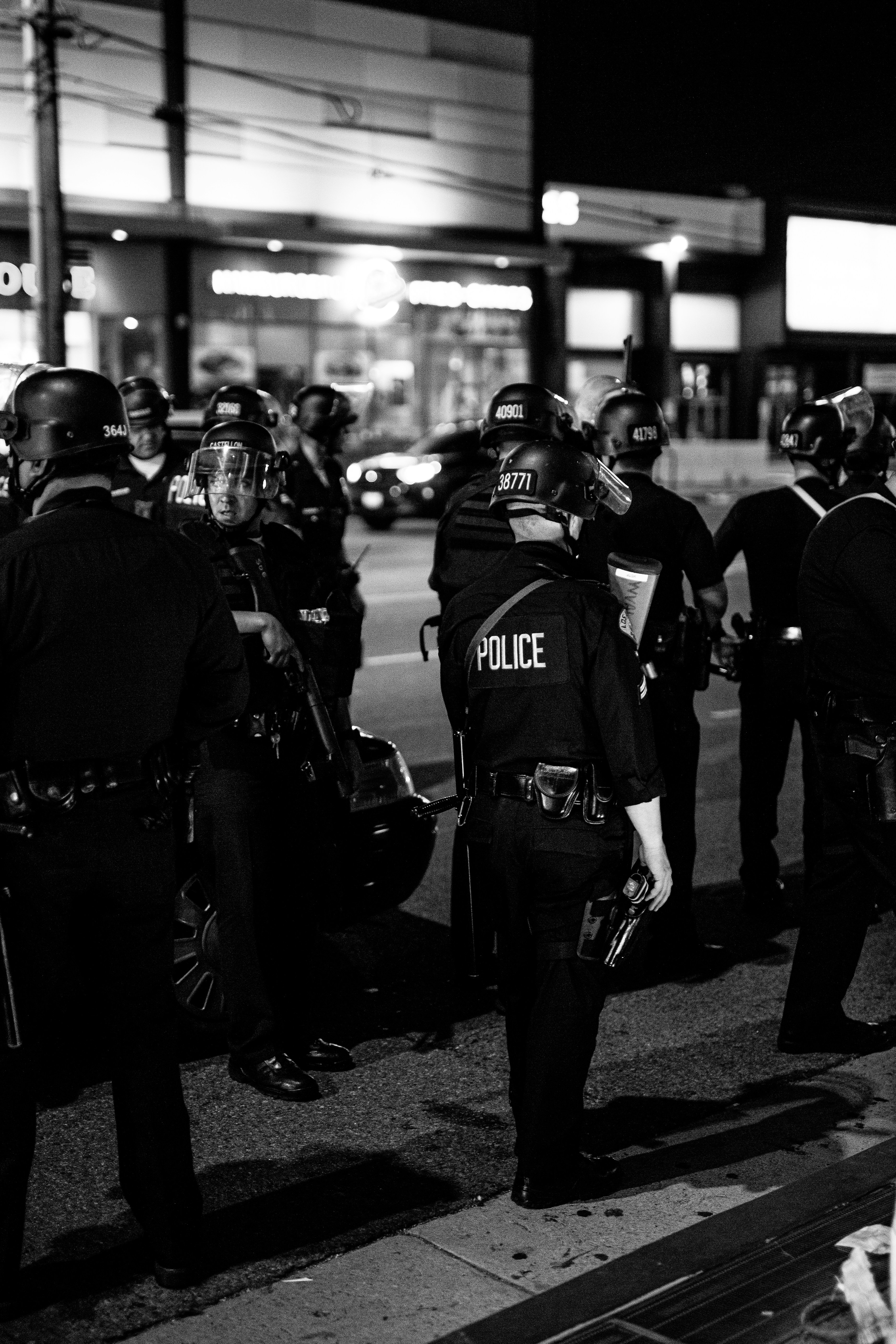 grayscale photo of 2 men in police uniform standing on road