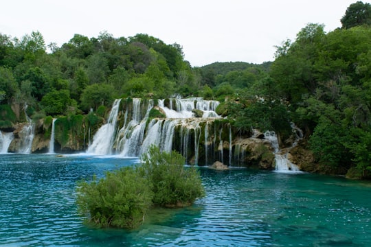 waterfalls near green trees during daytime in Krka National Park Croatia