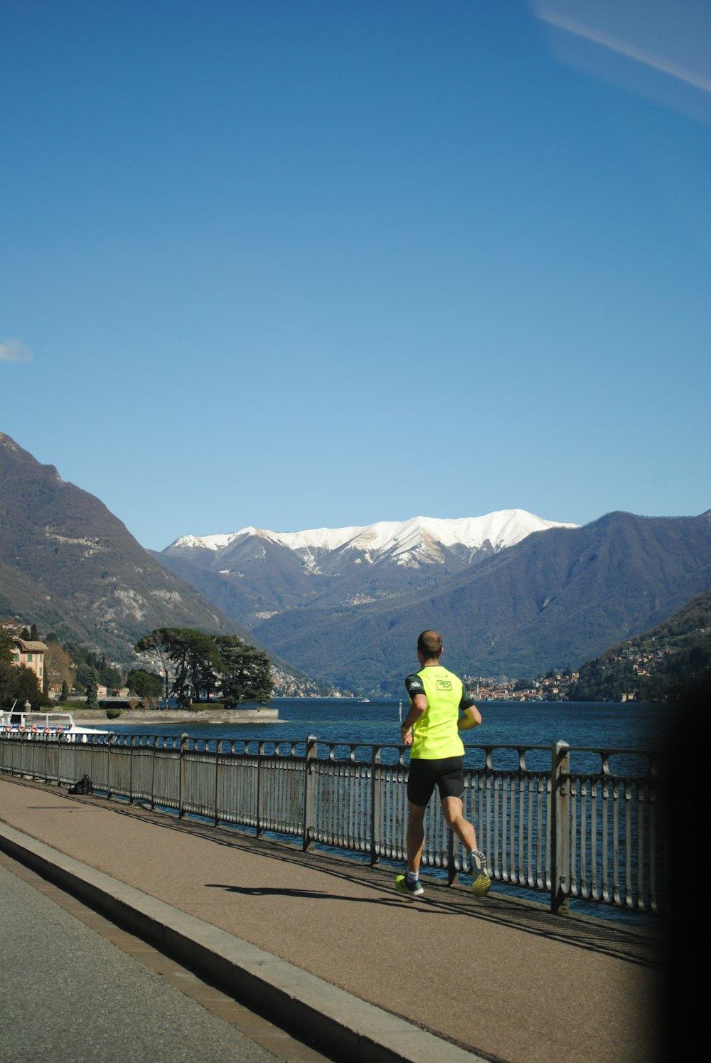 woman in yellow shirt standing on bridge during daytime