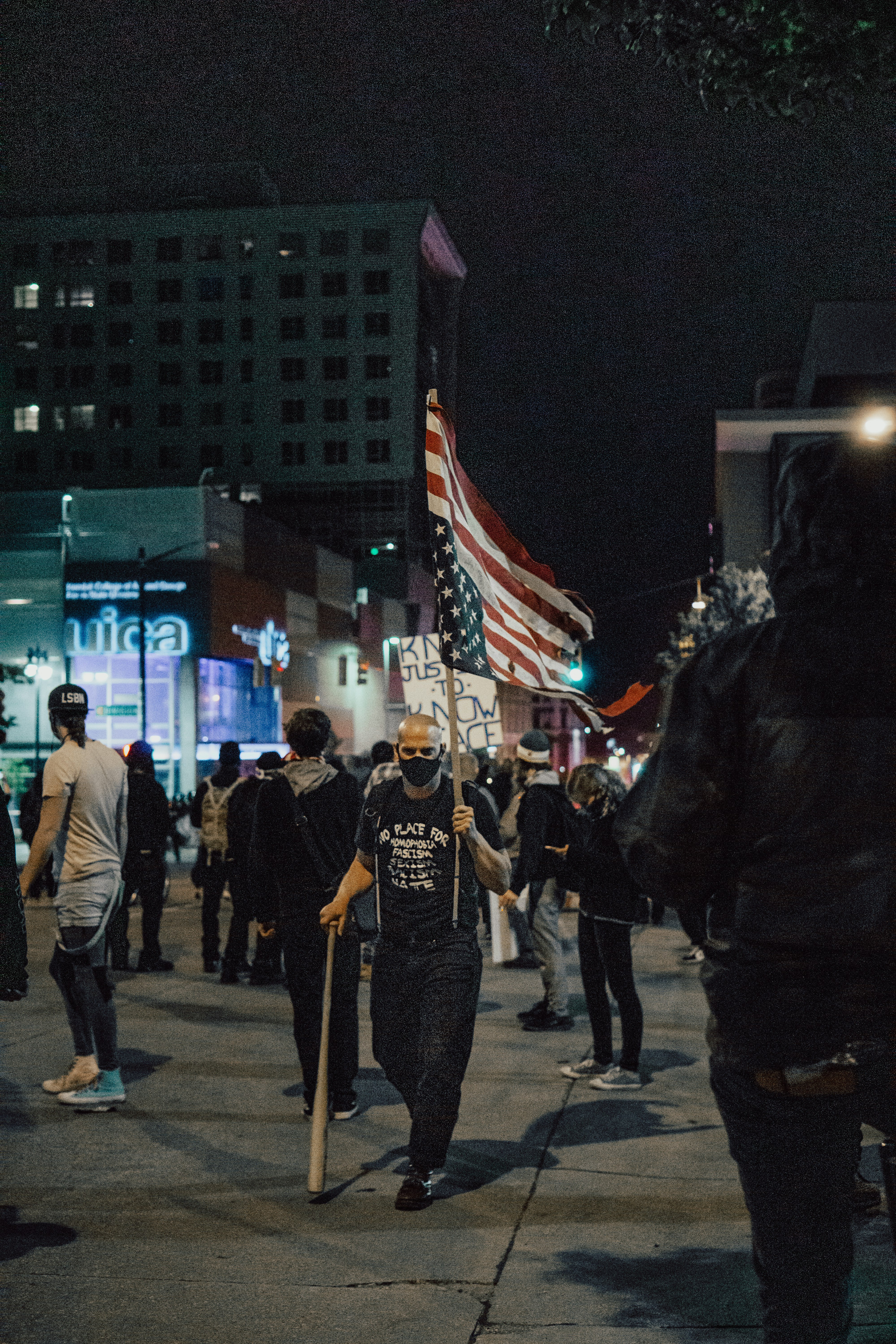 people walking on street during nighttime