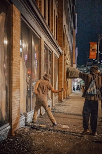 A tense standoff between two survivors in a ruined urban environment.