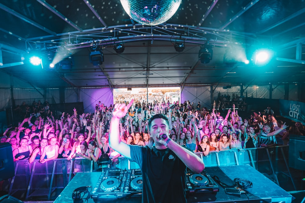 man in black t-shirt standing on stage