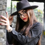 woman in black leather jacket wearing black hat