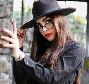 woman in black leather jacket wearing black hat