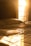 A person happily waking up in a sunlit bedroom, looking refreshed and ready for the day.