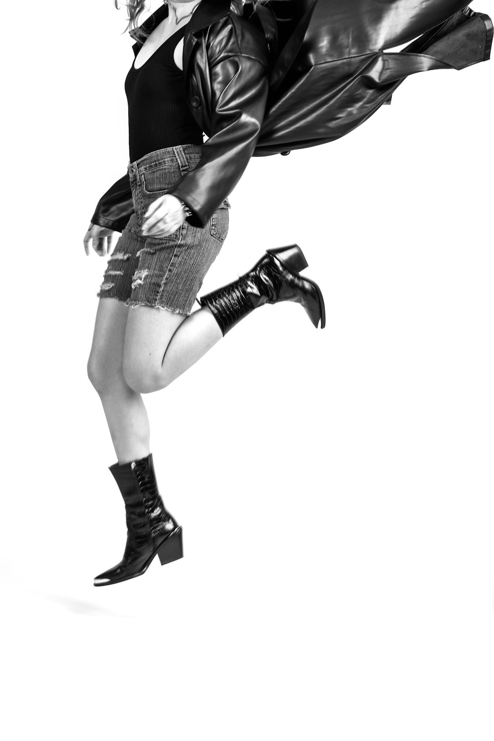 grayscale photo of woman in black leather boots