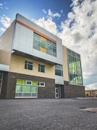 Finished modern building facade featuring gray and blue tones with orange accents.