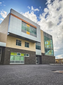 Finished modern building facade featuring gray and blue tones with orange accents.
