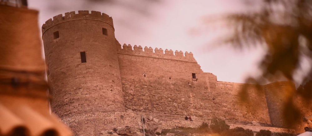 brown concrete castle under cloudy sky