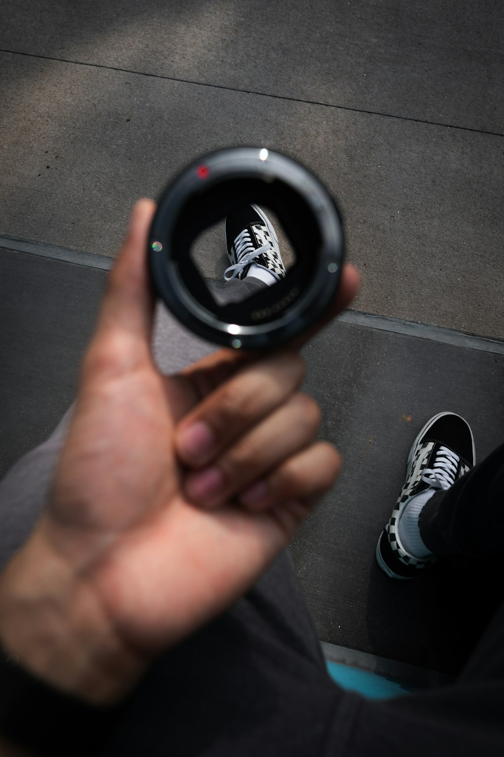 person holding black round device