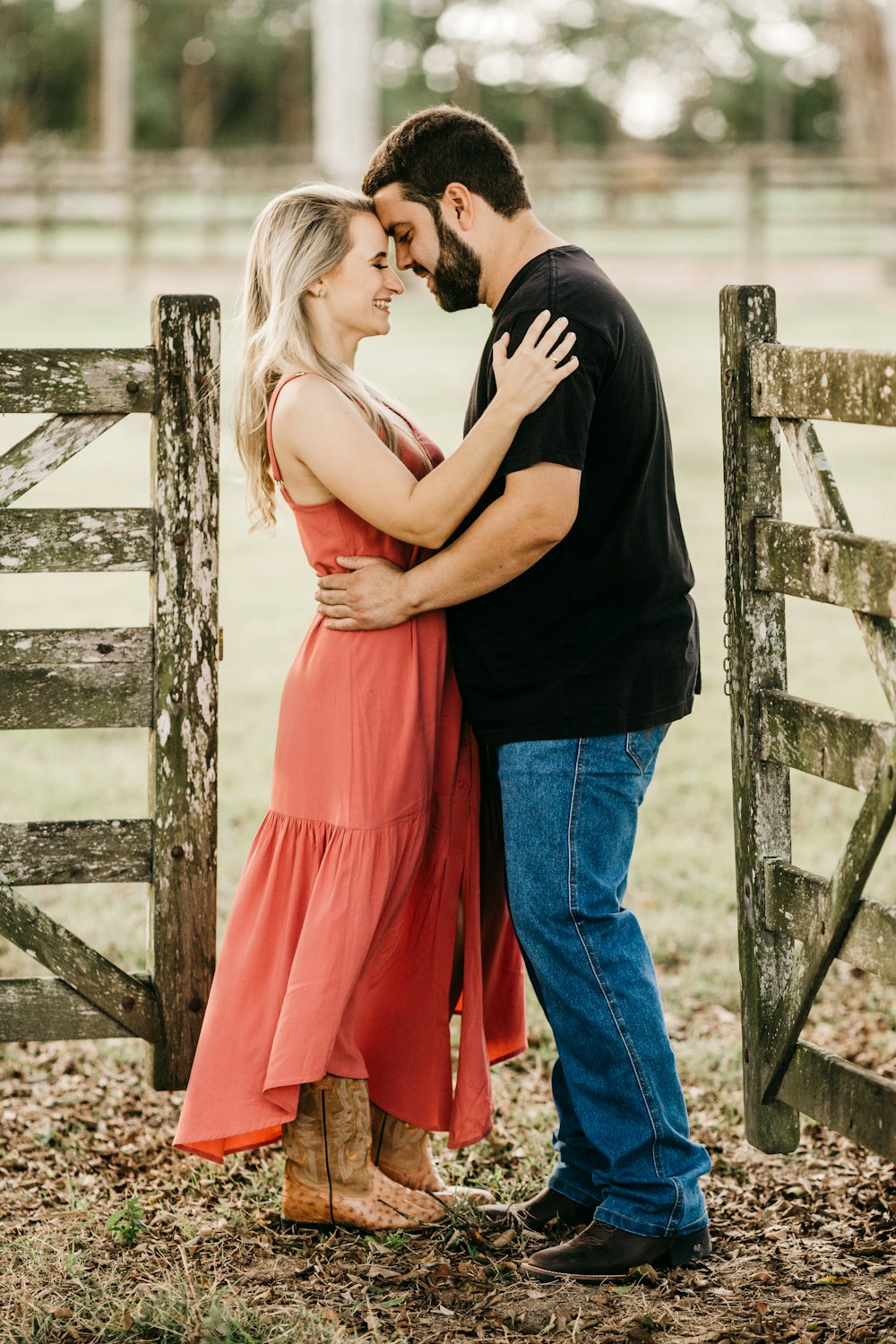 man in black t-shirt and woman in orange sleeveless dress