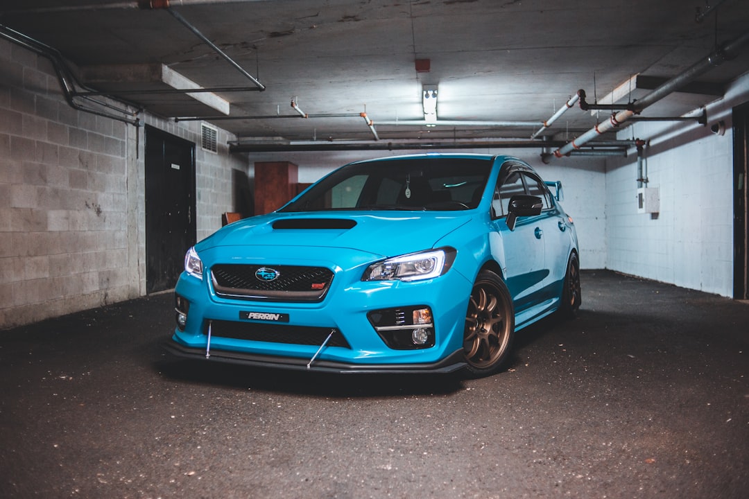 blue bmw m 3 parked in garage