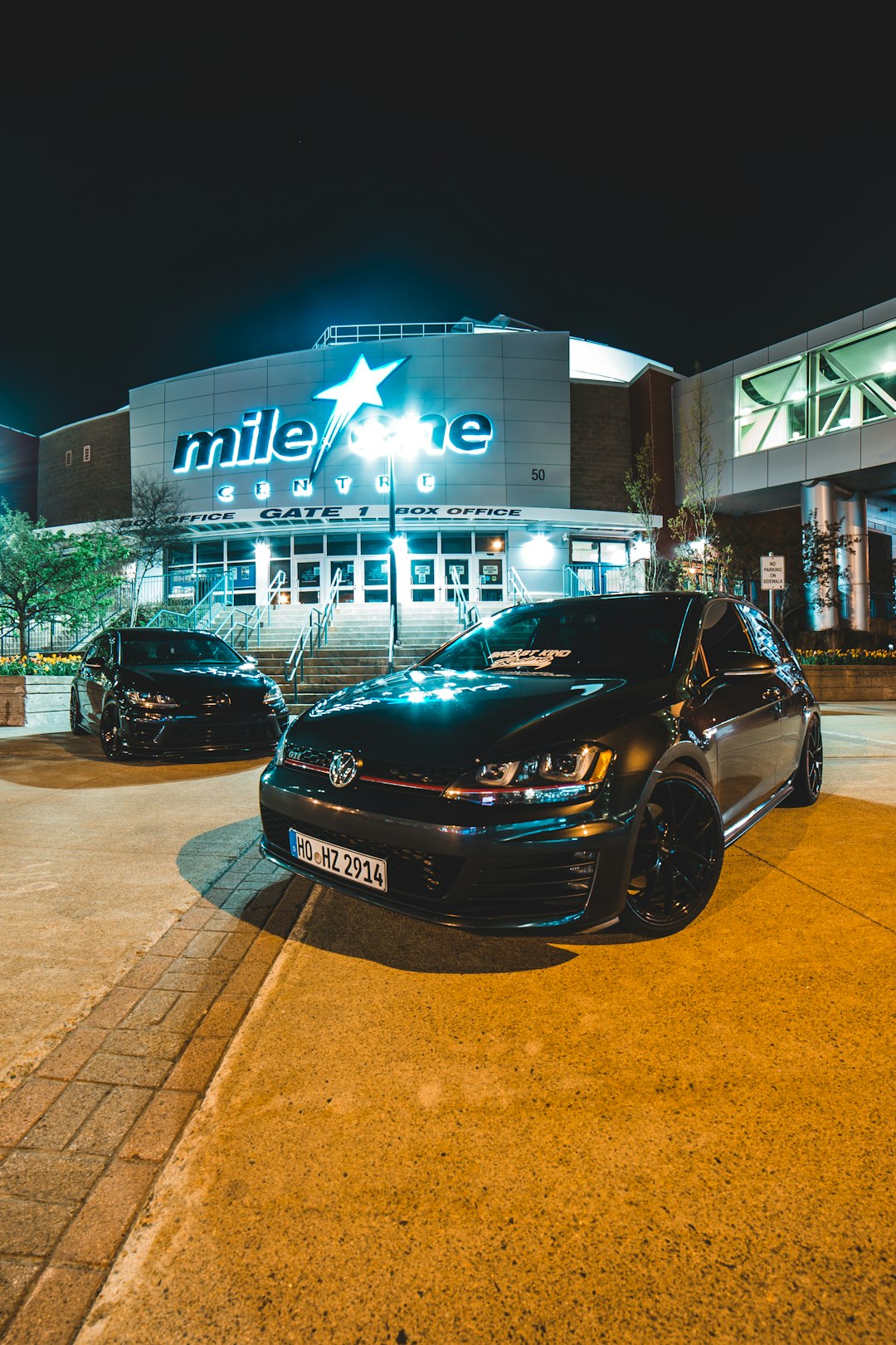 black car parked in front of white and blue building