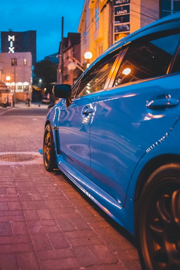 blue car on the road during daytime