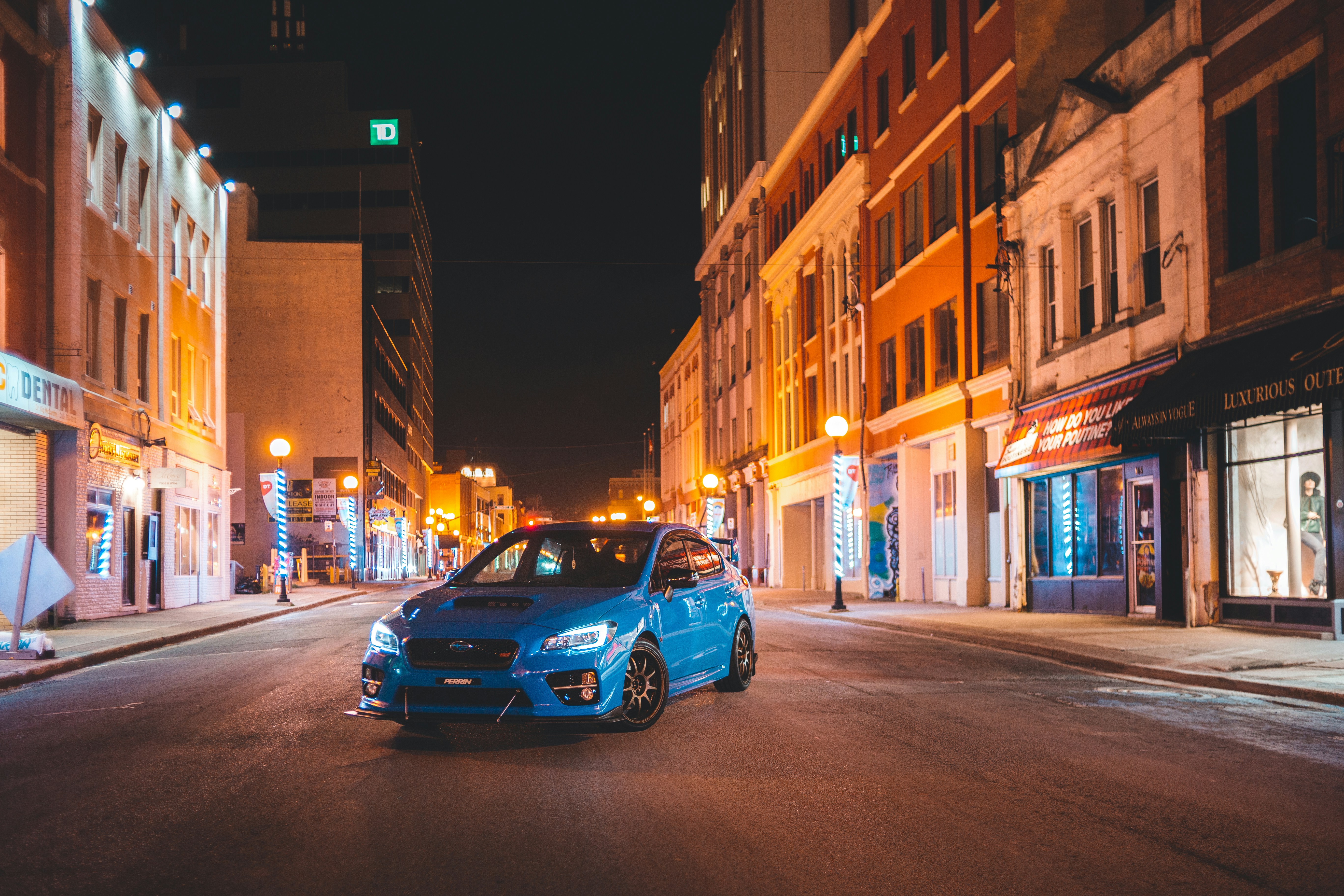 Hybrid car driving on a city street during commute