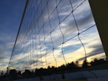 Volleyball net with a sunset backdrop over the Adelaide skyline.