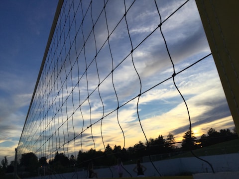 Volleyball net with a sunset backdrop over the Adelaide skyline.