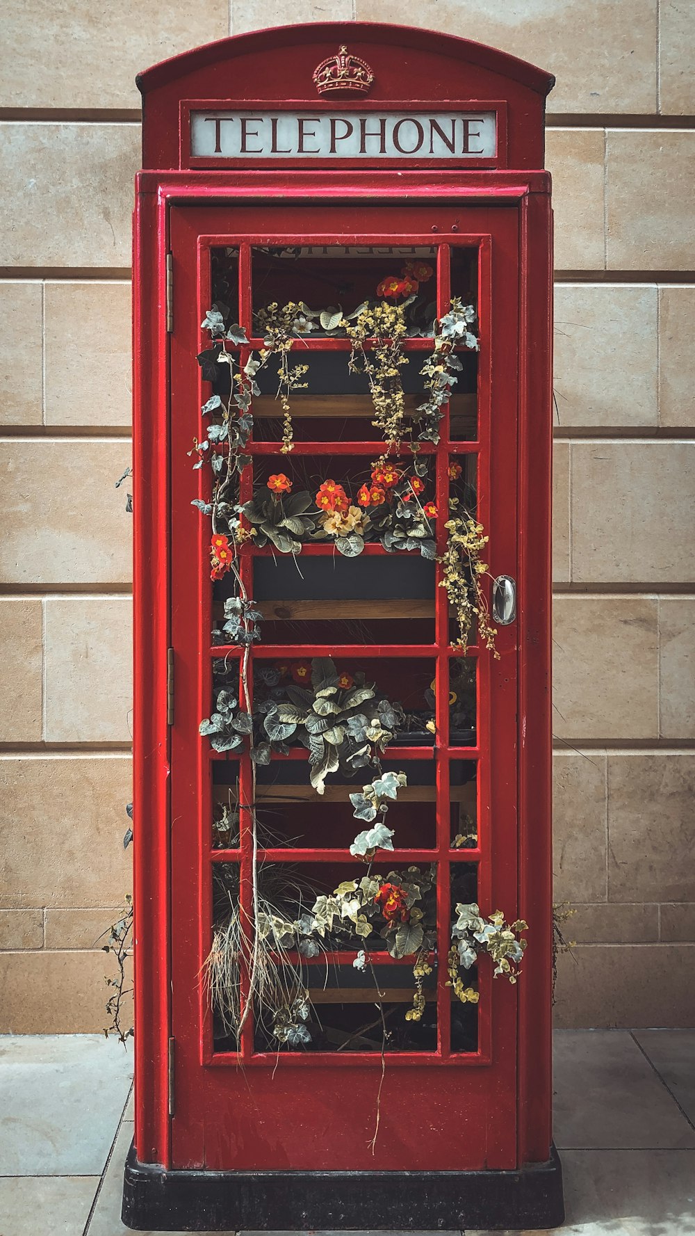 Porte en bois rouge avec des fleurs rouges et blanches