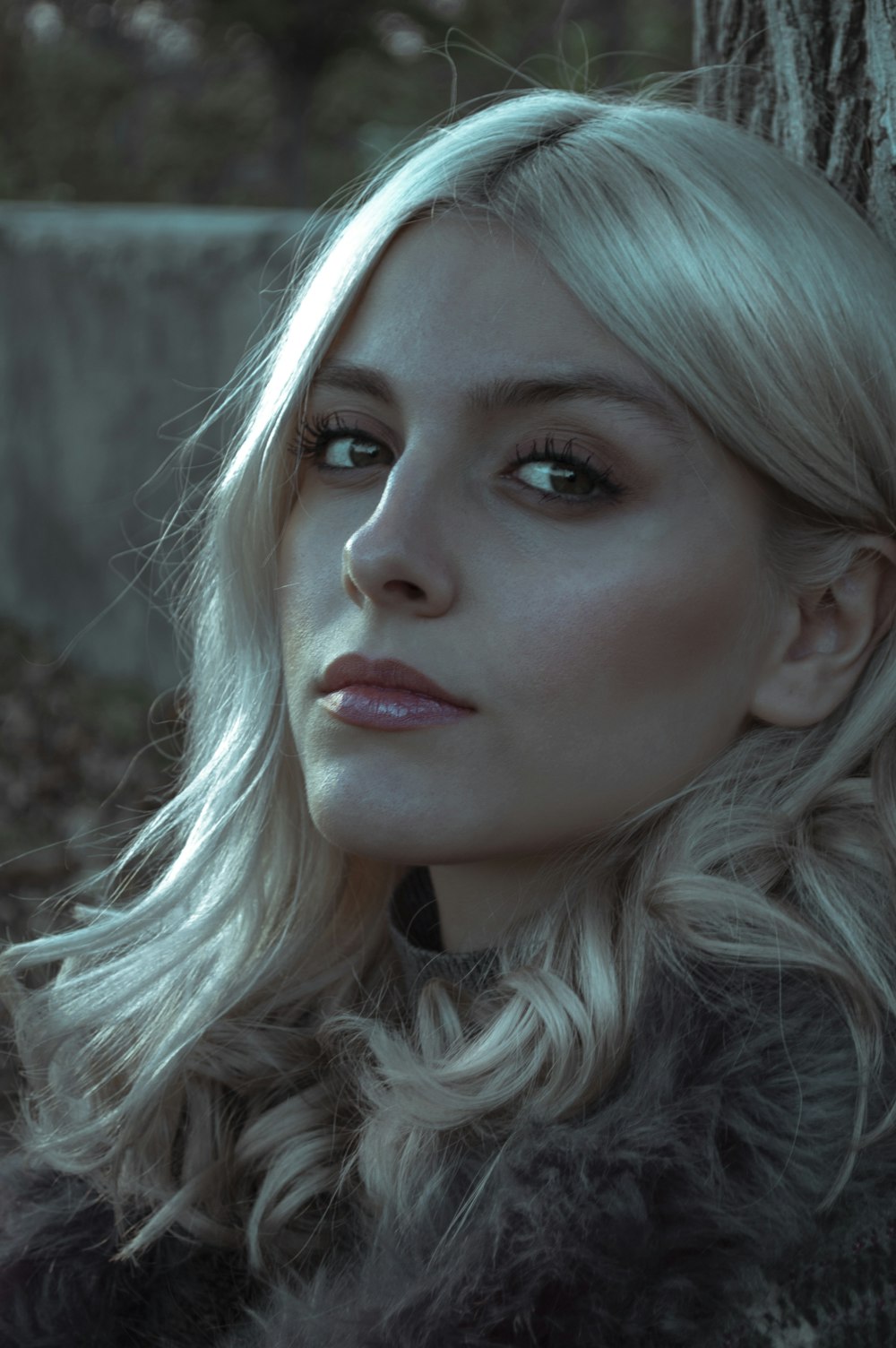 woman with blue hair and white and black fur coat