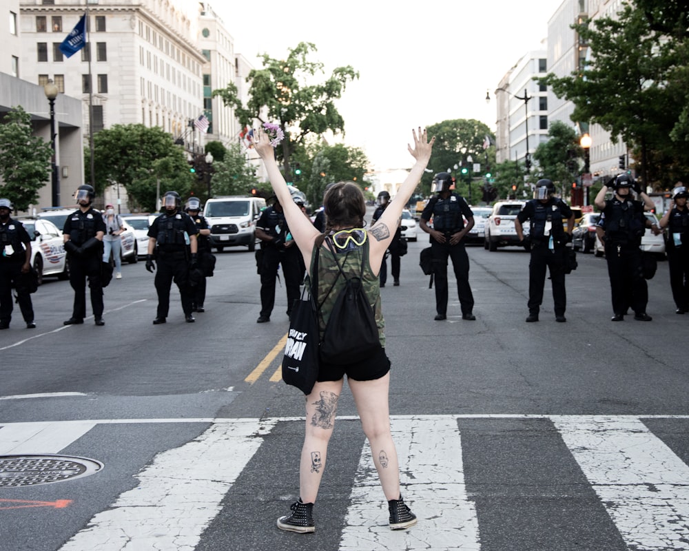 woman in green and black tank top raising her hands