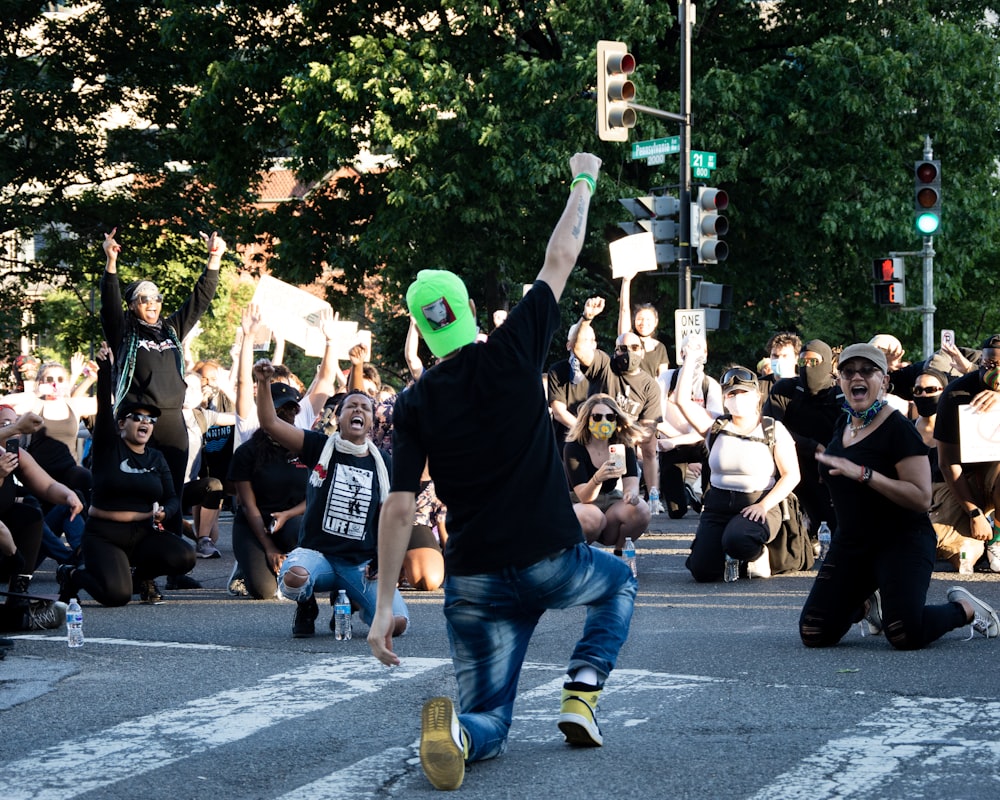 people in black shirt and blue denim jeans walking on street during daytime