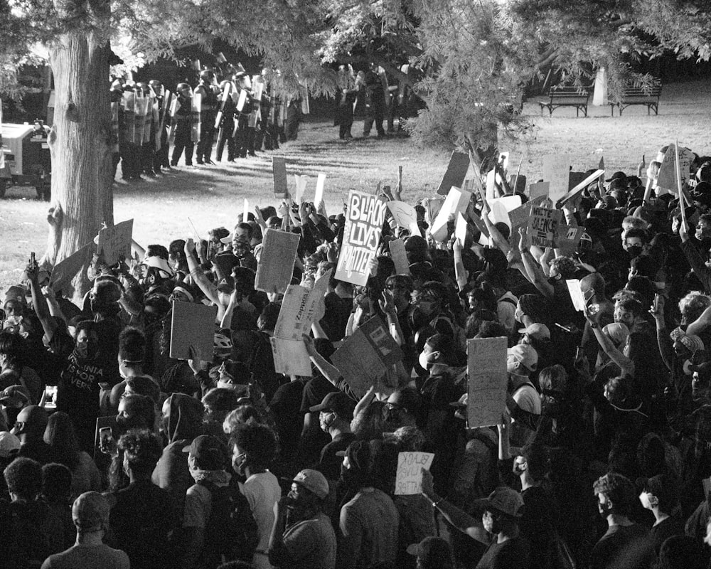 grayscale photo of people standing on road