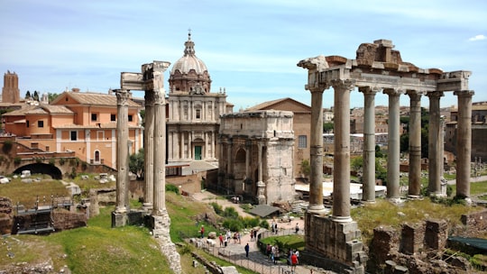 people walking near white concrete building during daytime in Roman Forum Italy