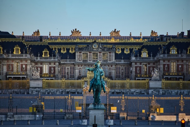 green statue of man riding horse near white building during daytime