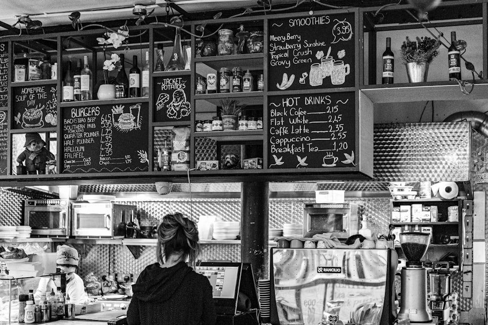 woman in black long sleeve shirt standing in front of store