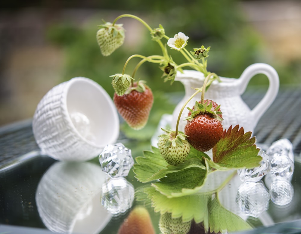 red strawberries on white ceramic mug