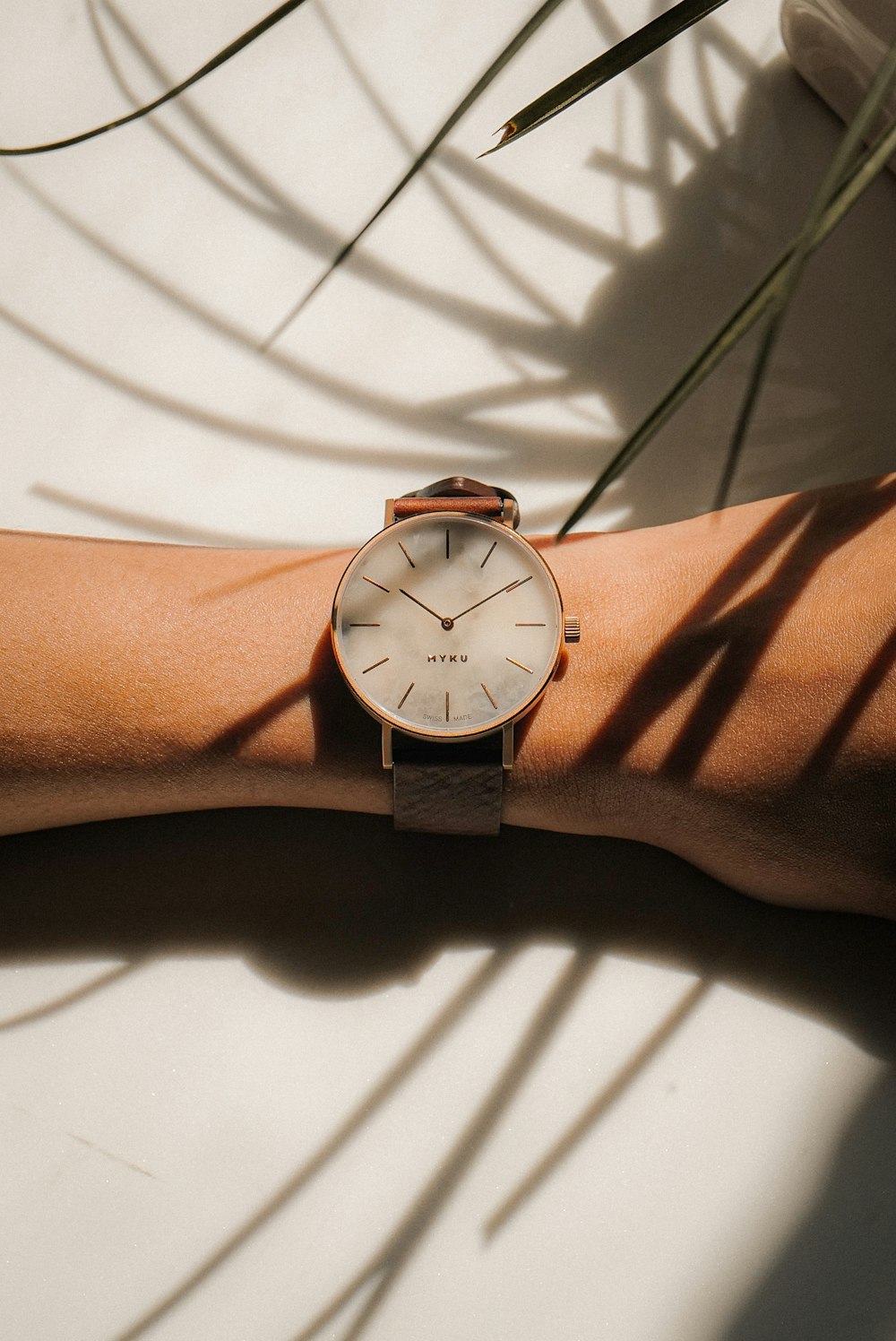 person wearing silver round analog watch