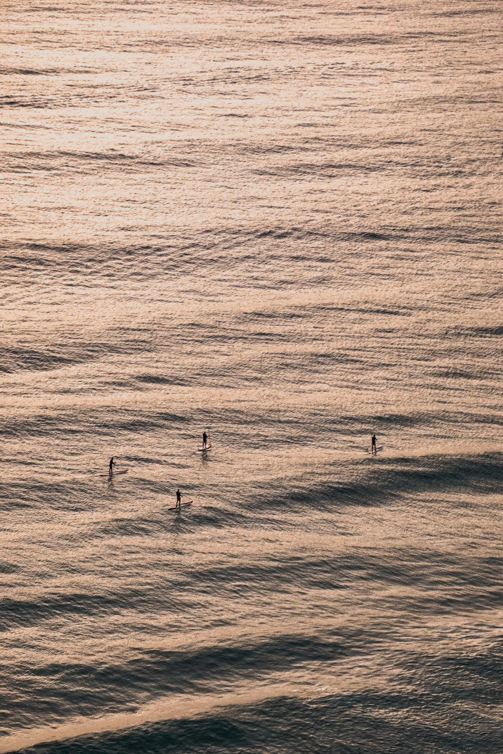 3 white wind turbines on sea during daytime