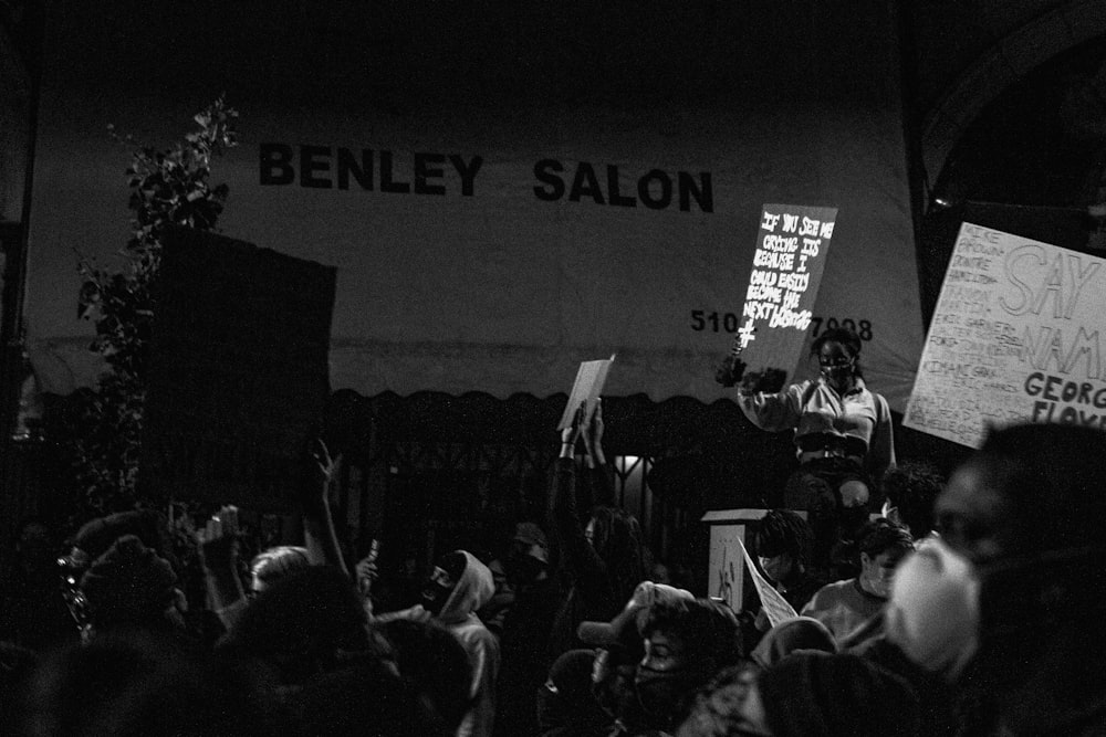 grayscale photo of people on stage