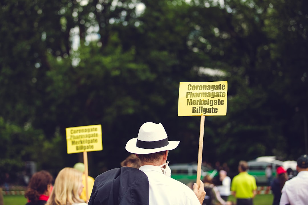 people holding signage during daytime